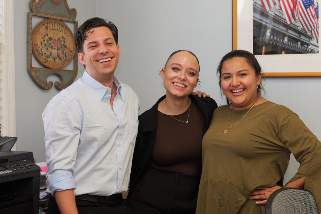 Members of the Plaza Insurance team smiling in the office