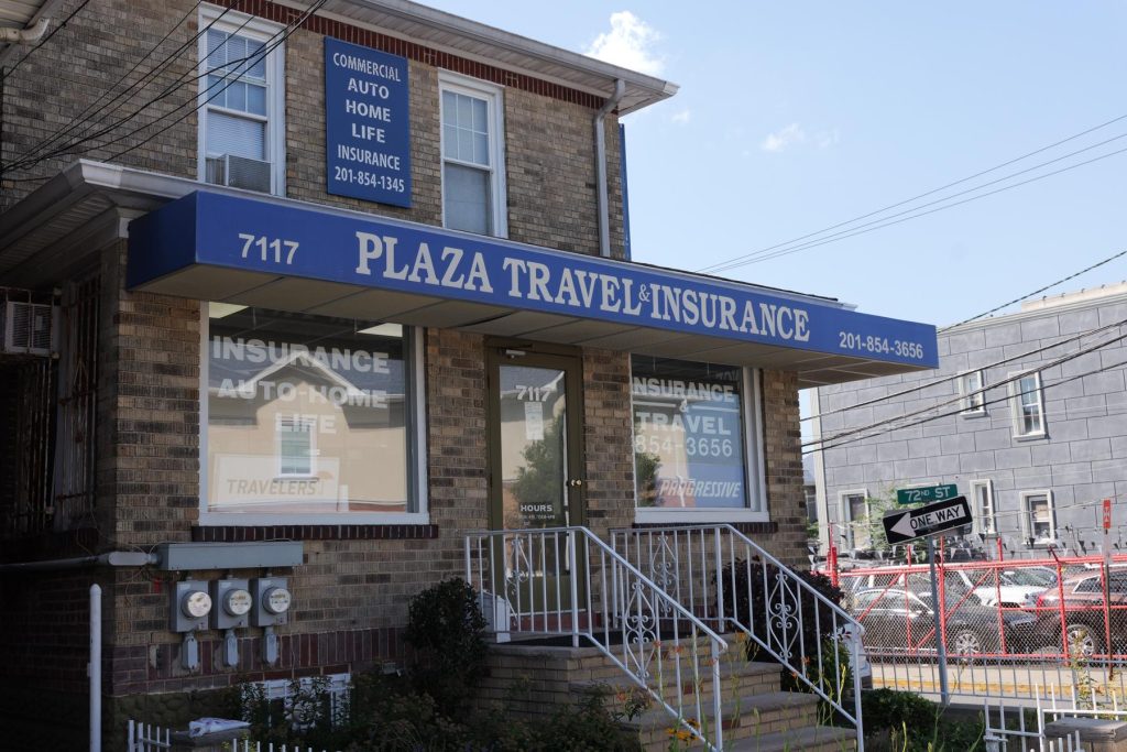 The Plaza Insurance storefront with its blue awning